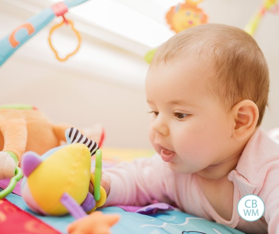 4-6 month old child playing with toys