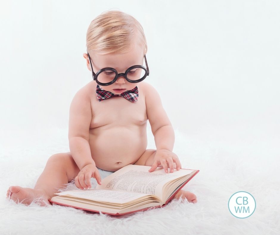 Textbook baby looking at book