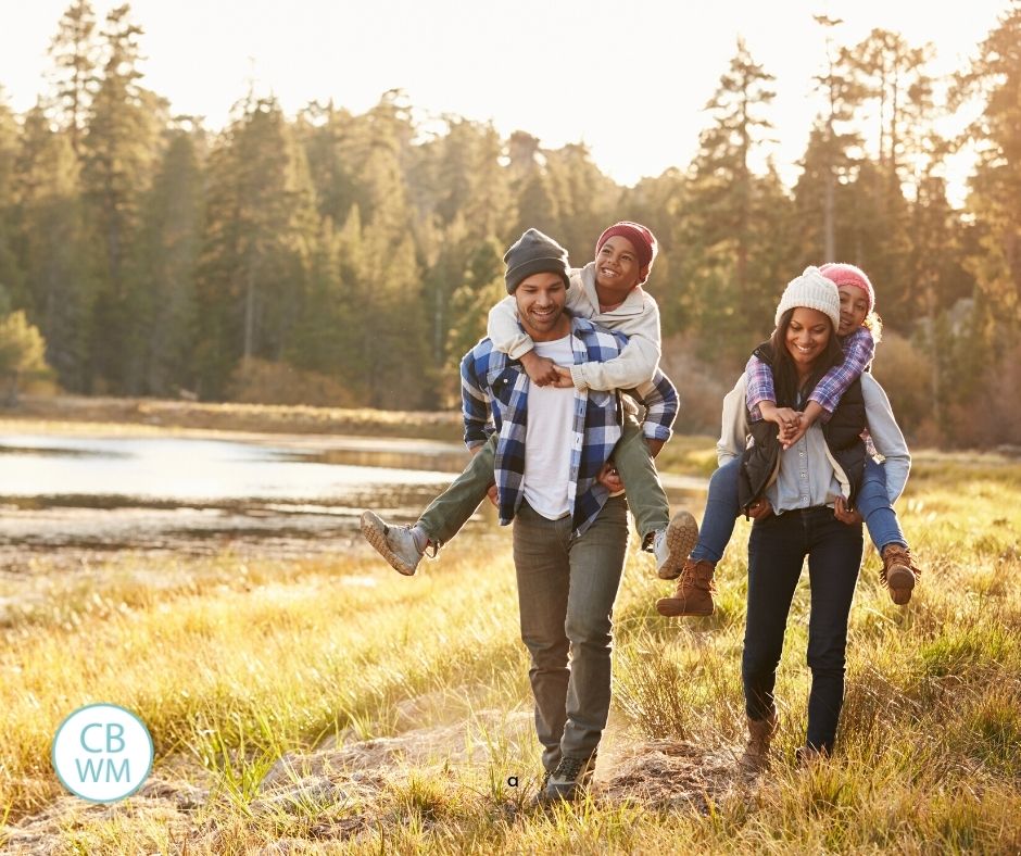 family of four kids on parents backs