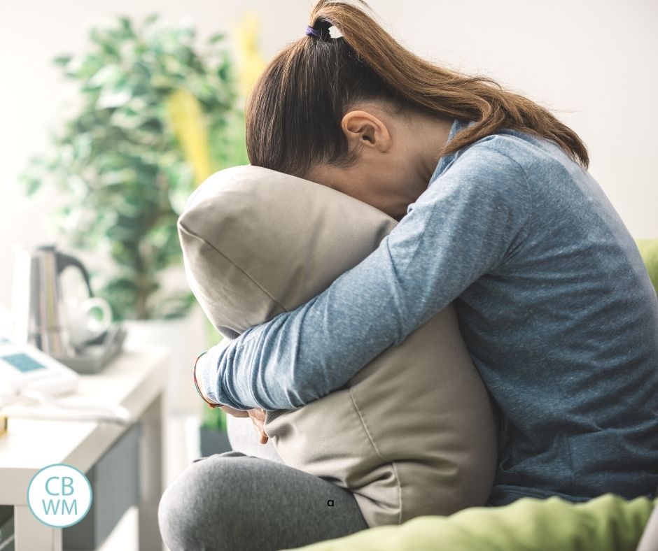 woman crying into a pillow