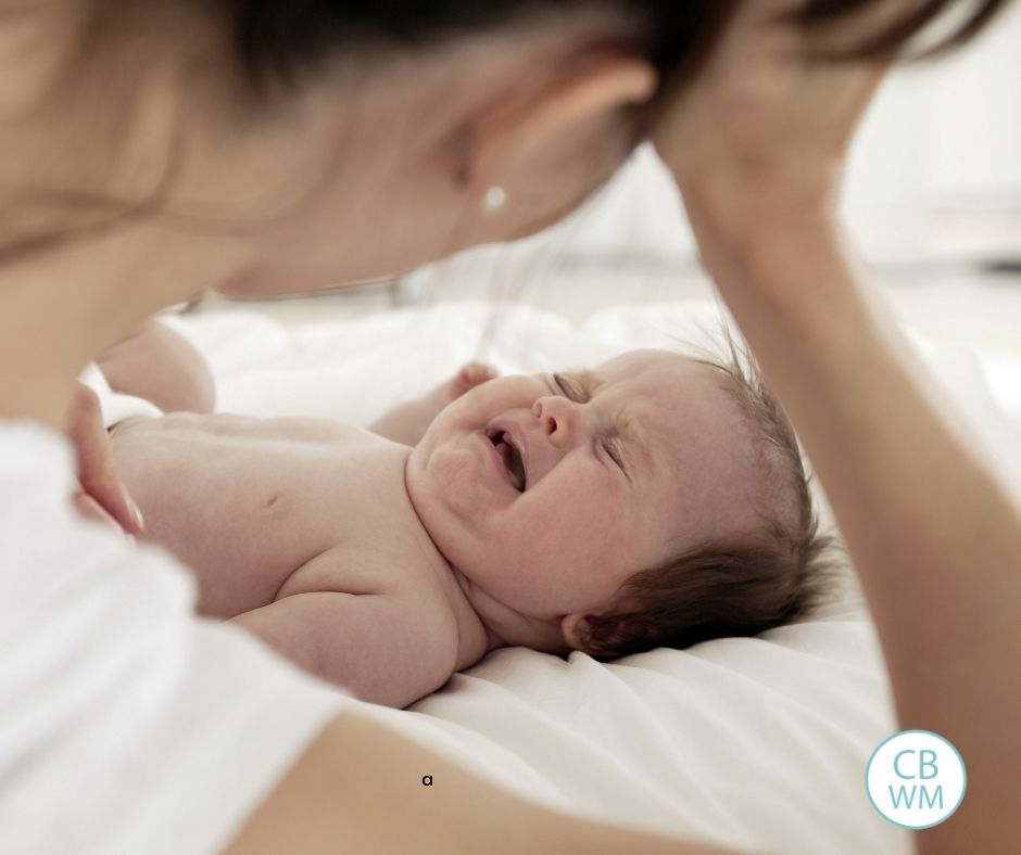 mother looking at crying baby