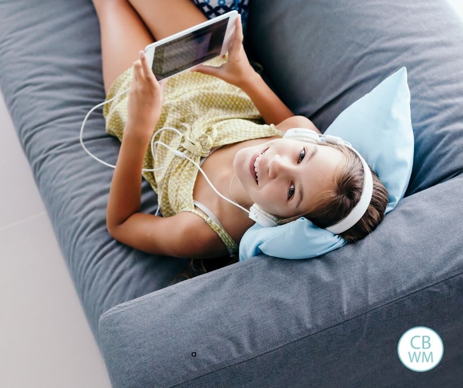 Tween on the couch with a tablet