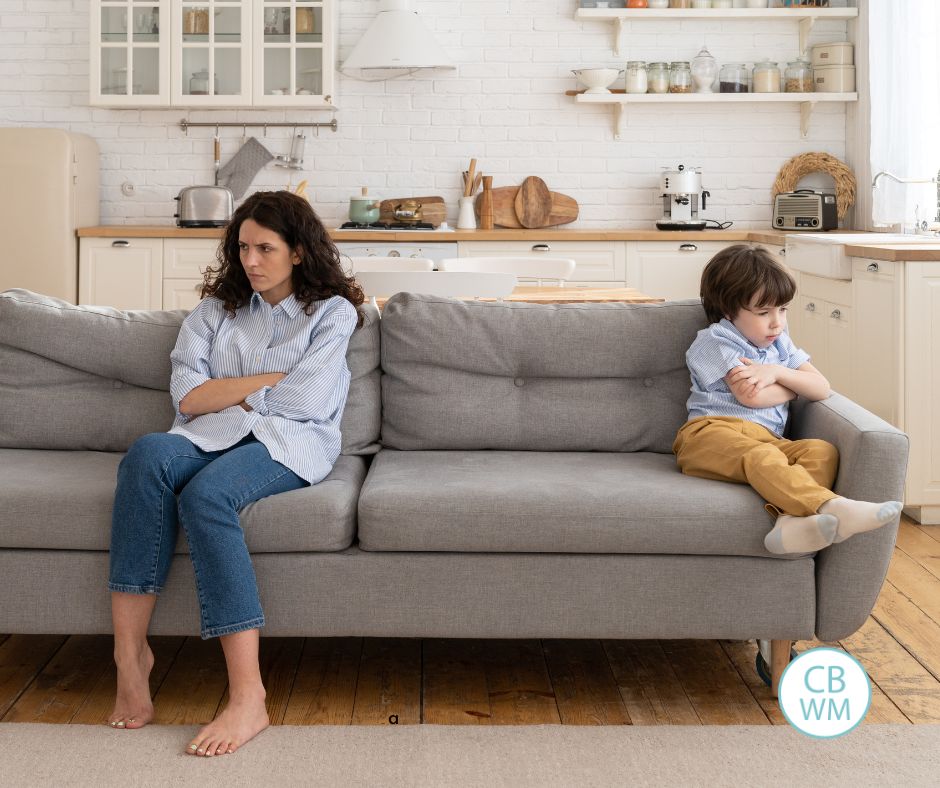 frustrated mom and her child sitting on the couch