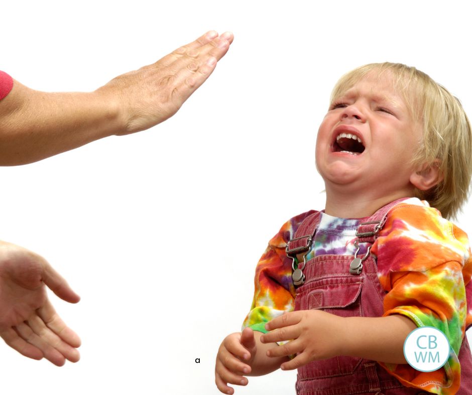 Child having a tantrum with the parent holding hands out
