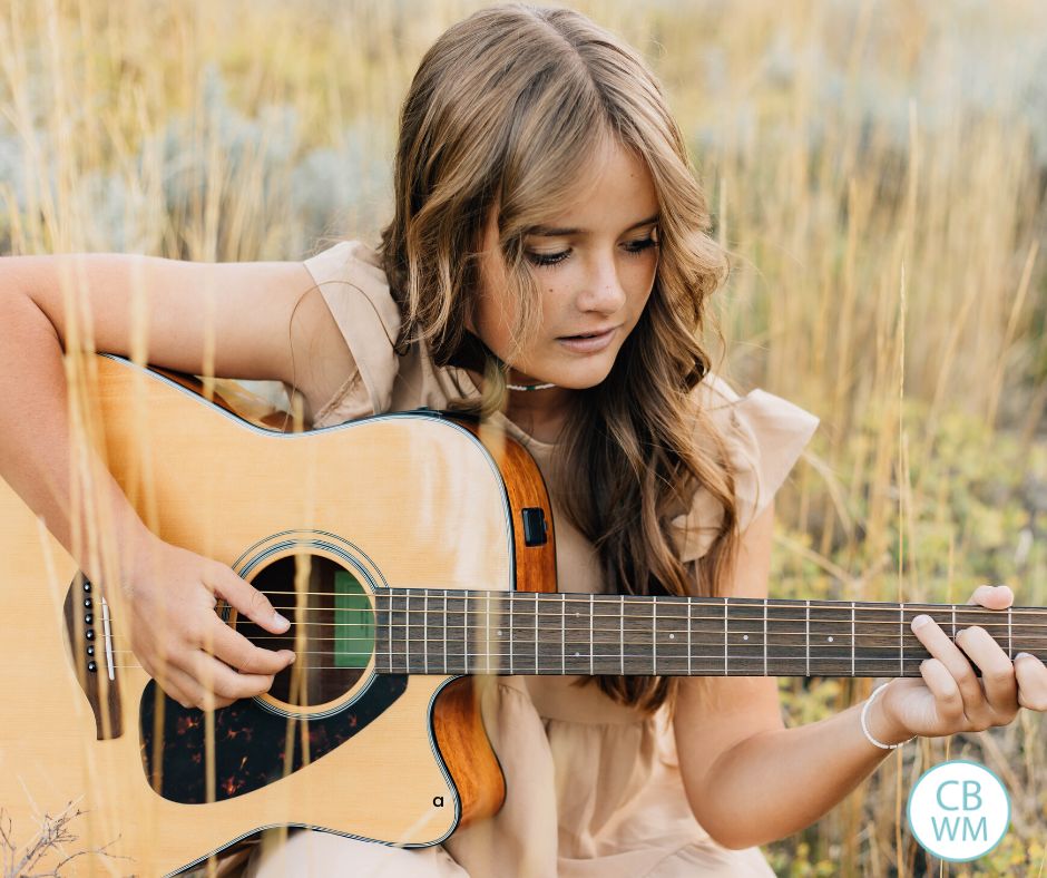 15 year old teen playing the guitar