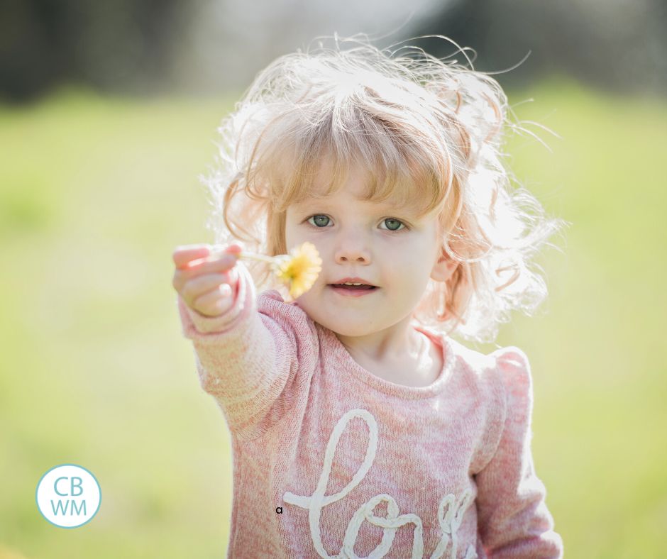 Toddler holding a flower