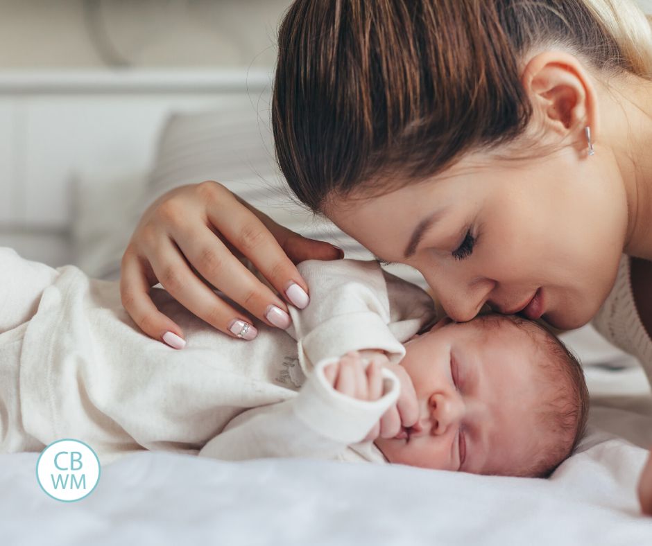 Mom cuddling newborn baby