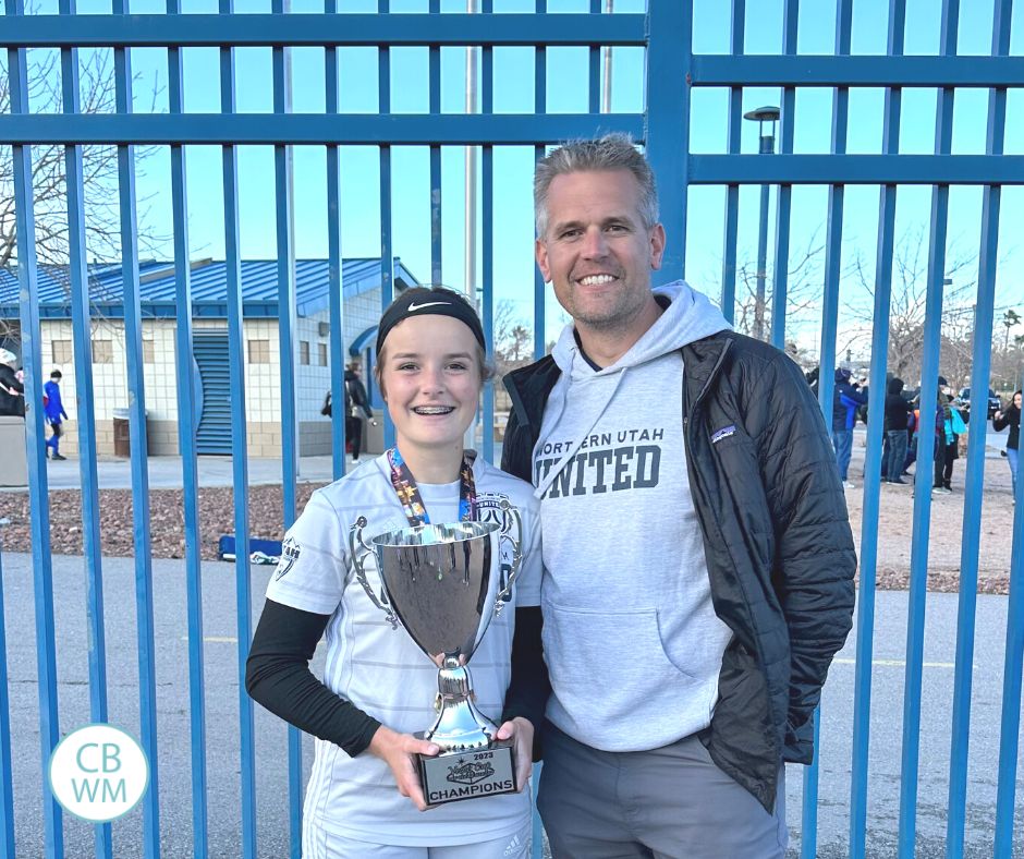 15 year old Kaitlyn and her dad holding a trophy