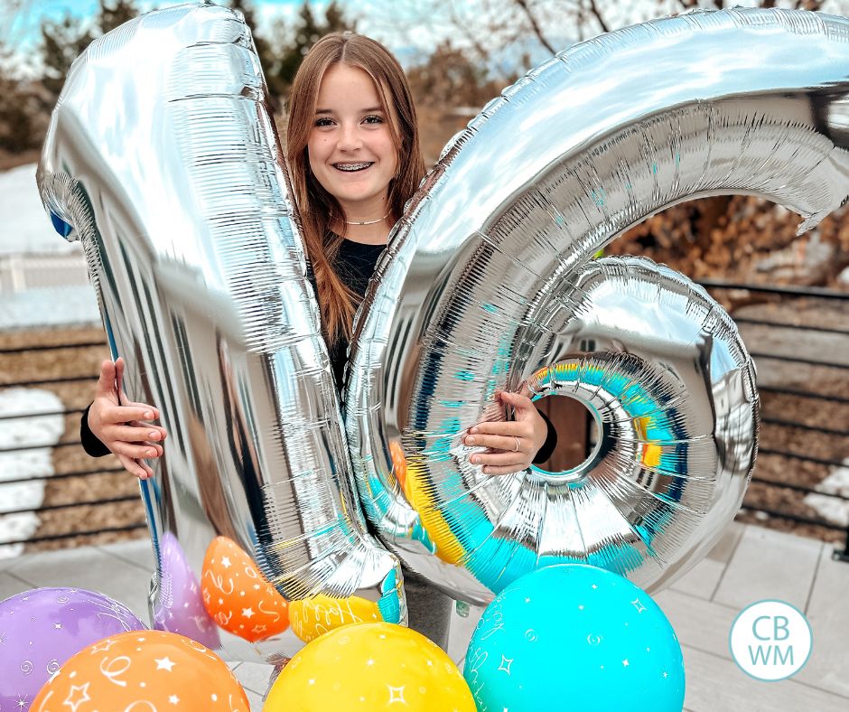 16 year old Kaitlyn holding birthday balloons