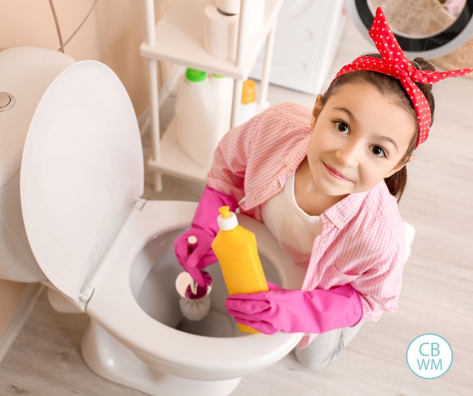 Child cleaning a toilet