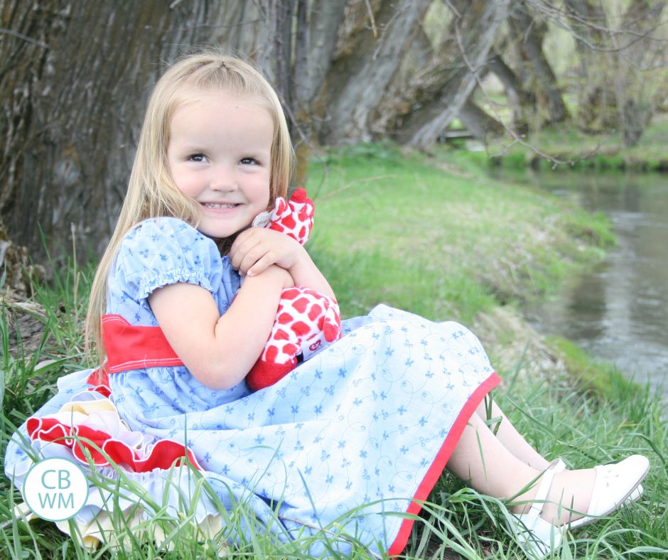 4 year old sitting by a creek