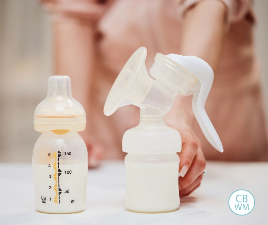 Woman holding a breast pump with a bottle of expressed milk