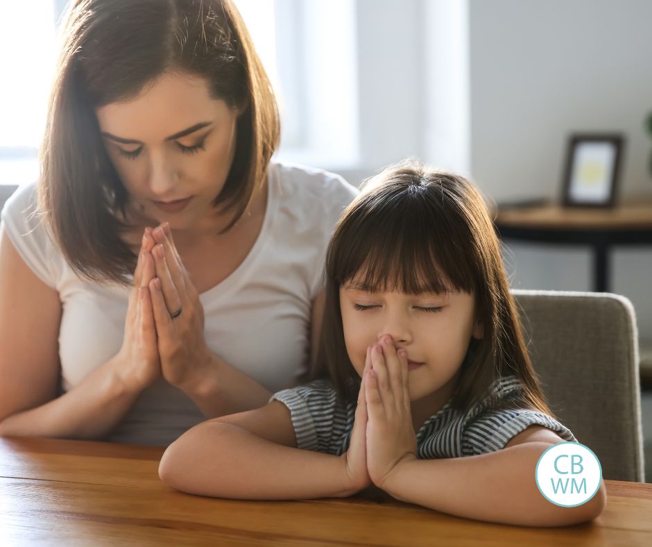 Mom and daughter praying
