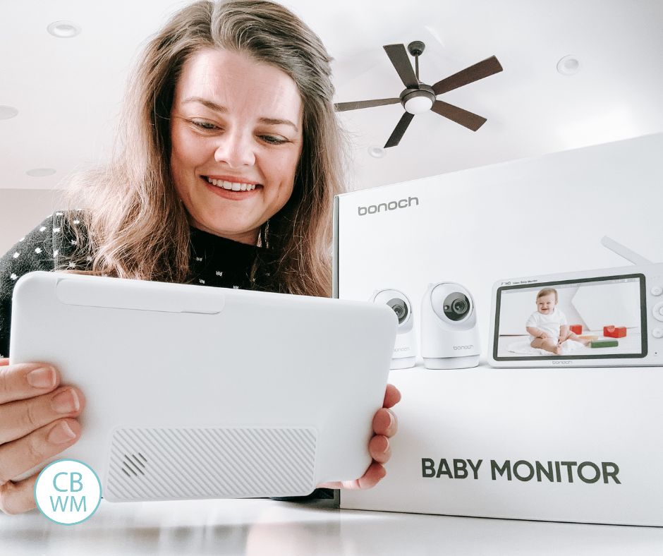 Mom looking at the monitor of a baby video monitor