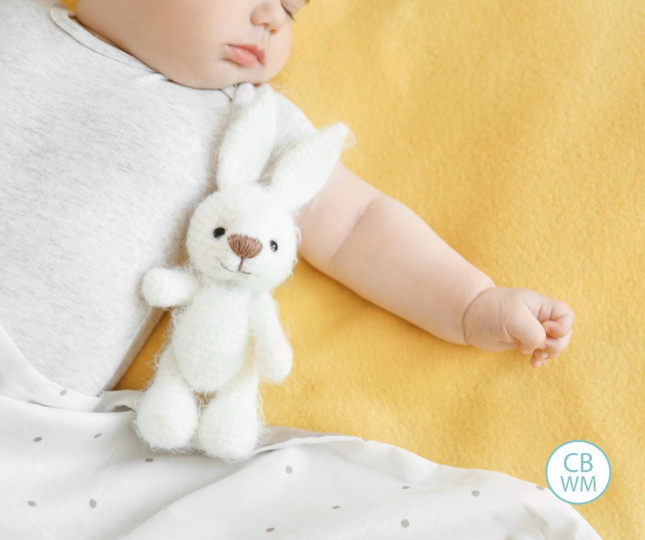 Baby sleeping on yellow sheet. You just see part of baby's face