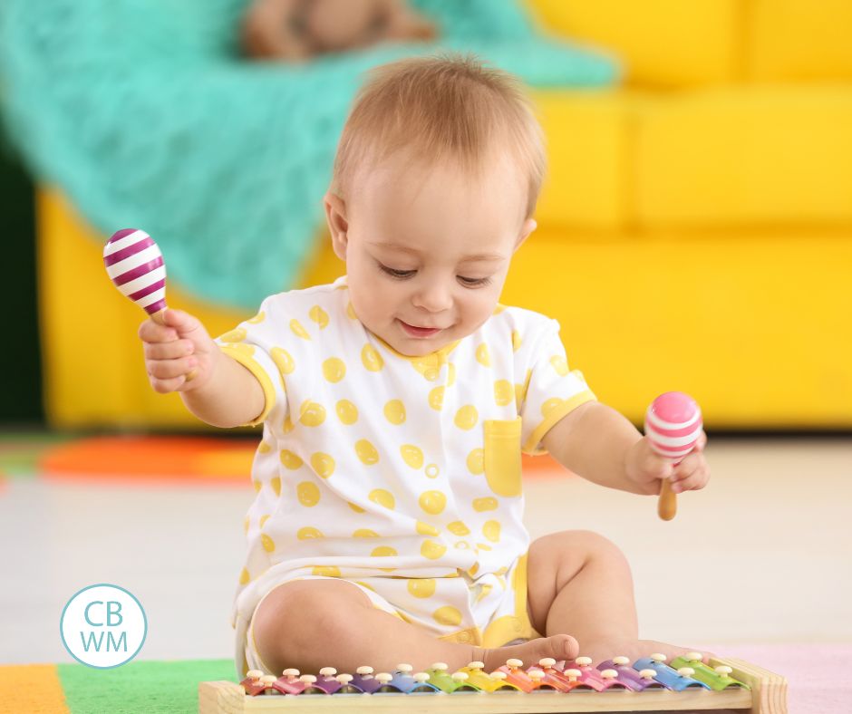 Baby sitting on the floor playing with toys