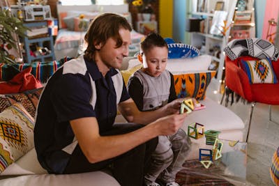 Father and son playing with magnetic math toys