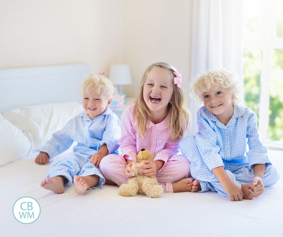 3 Kids in pajamas on a bed