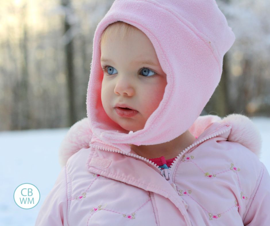 Baby in the winter standing outside