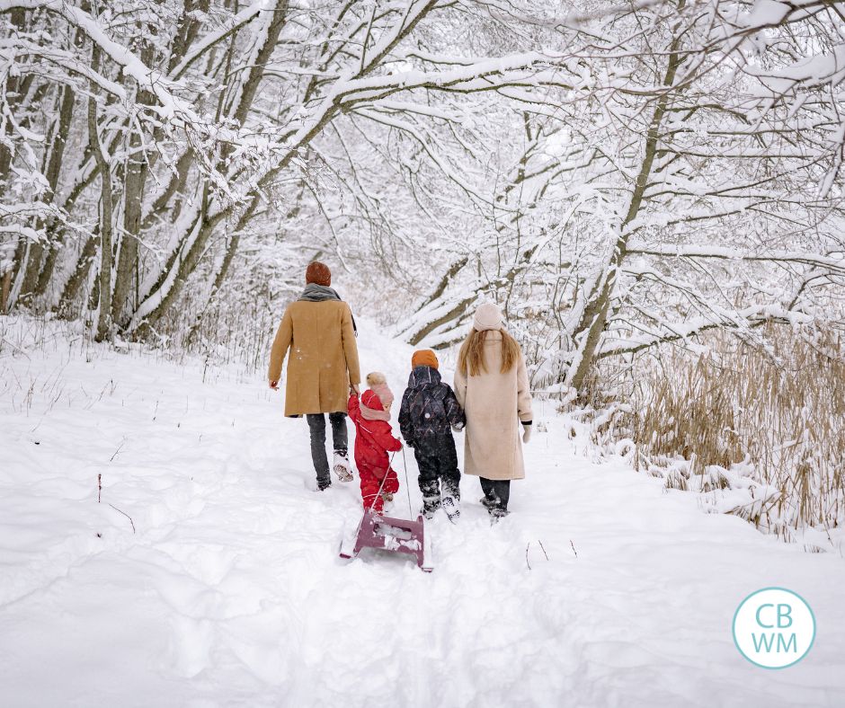 Family walking through the snow in the mountains