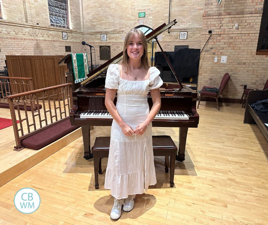Kaitlyn standing in front of a grand piano