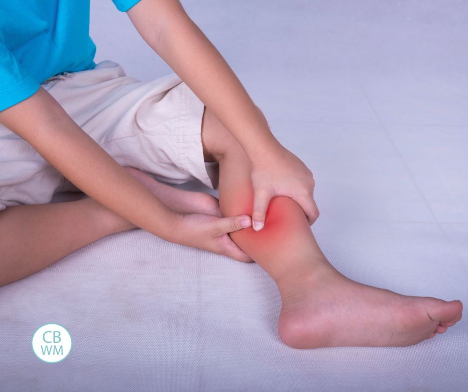 Child massaging pain in the calf