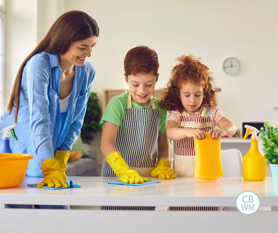 Mom doing chores with her two kids