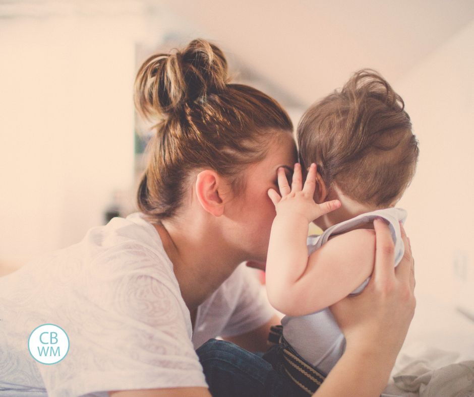 Mom giving baby a kiss
