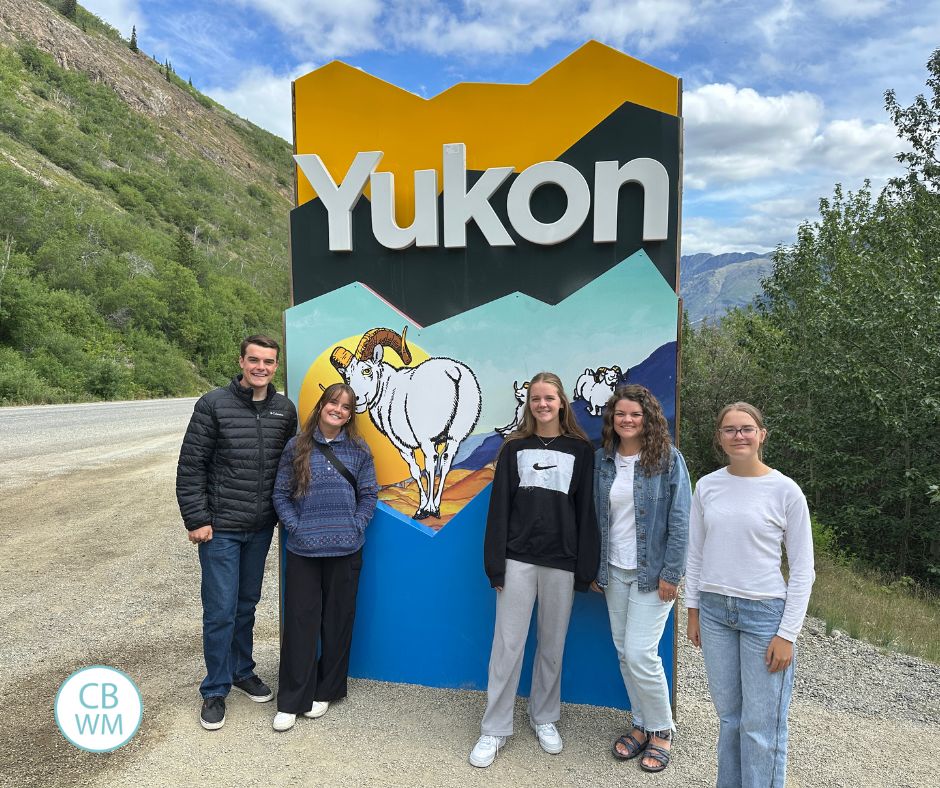 Welcome to Yukon sign wtih our family in front of it