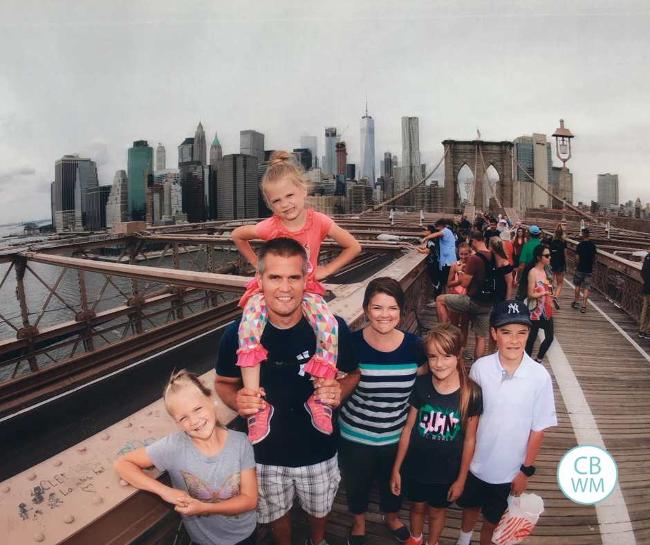Our family standing on the Brooklyn Bridge with NYC in the background