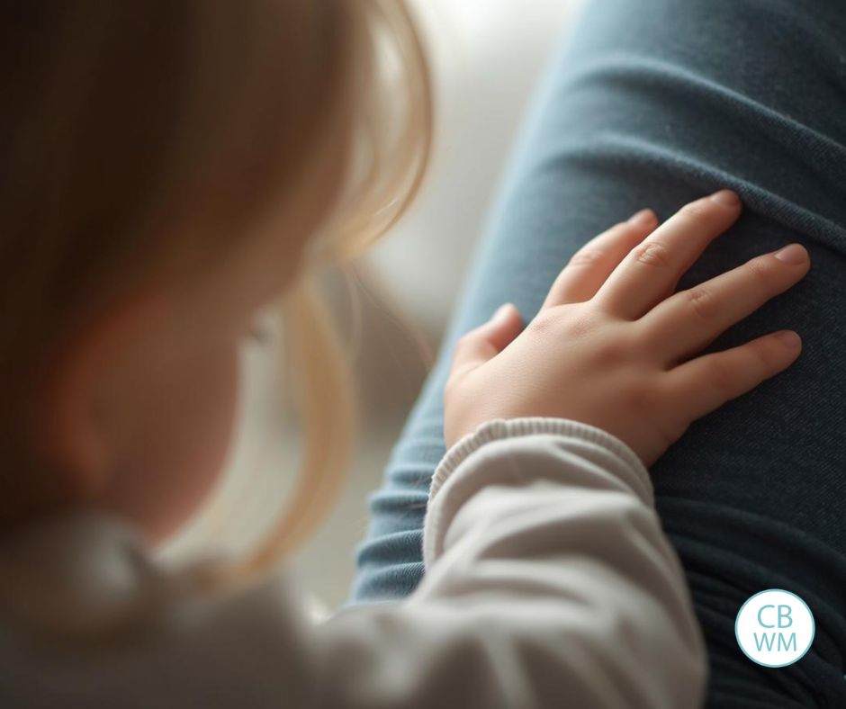 Child with the hand on the arm of the parent
