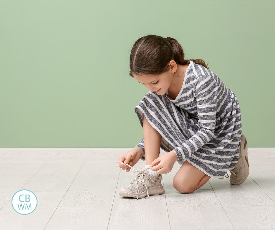 Picture of child tying her shoes