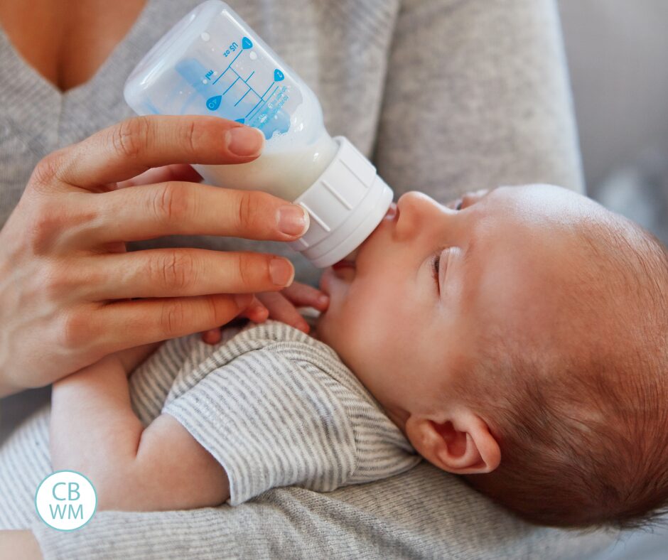 Newborn baby drinking form a bottle