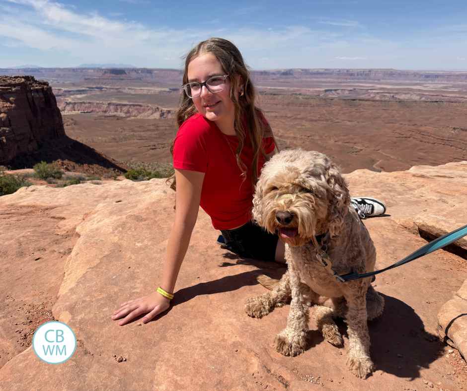 Brinley sitting in Canyonlands National Park with our dog