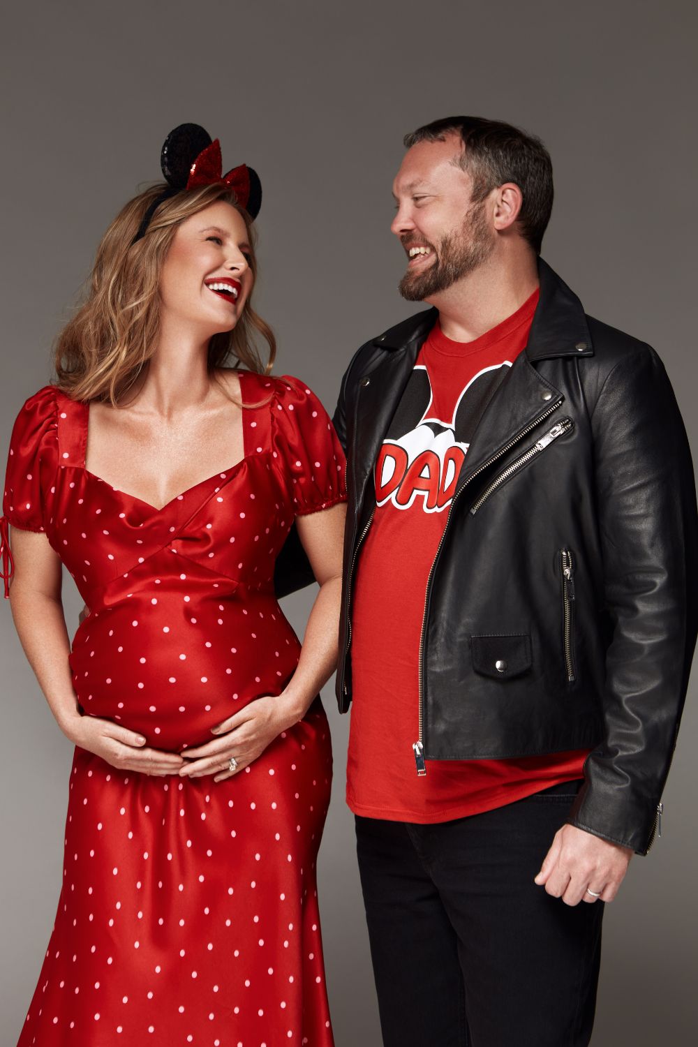 Playful maternity photos with husband and wife wearing disney clothes