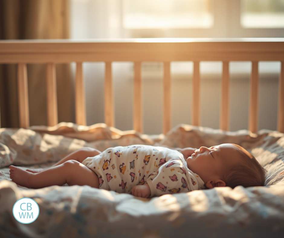baby sleeping in the crib with a sunrise coming through the window