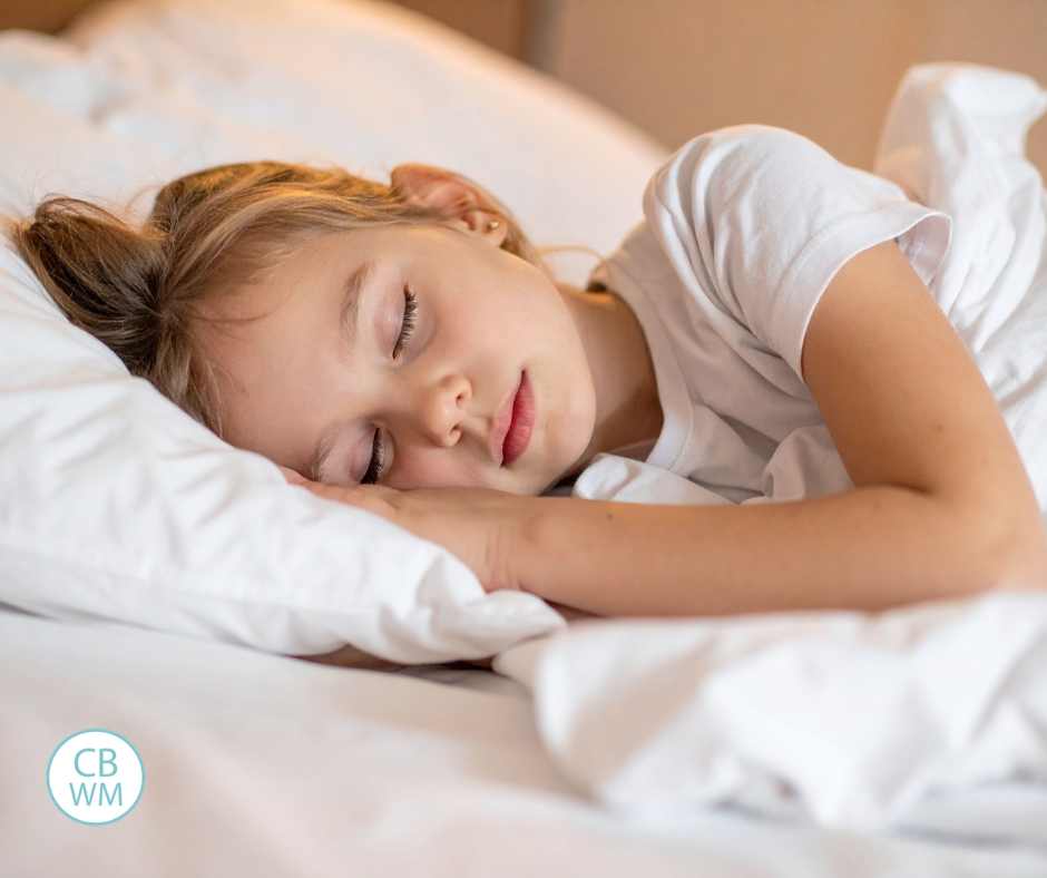 Girl sleeping on her side in her bed