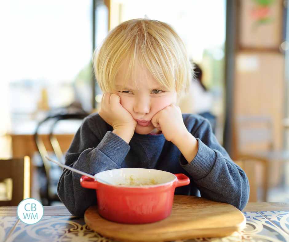 Picky toddler sitting at the table