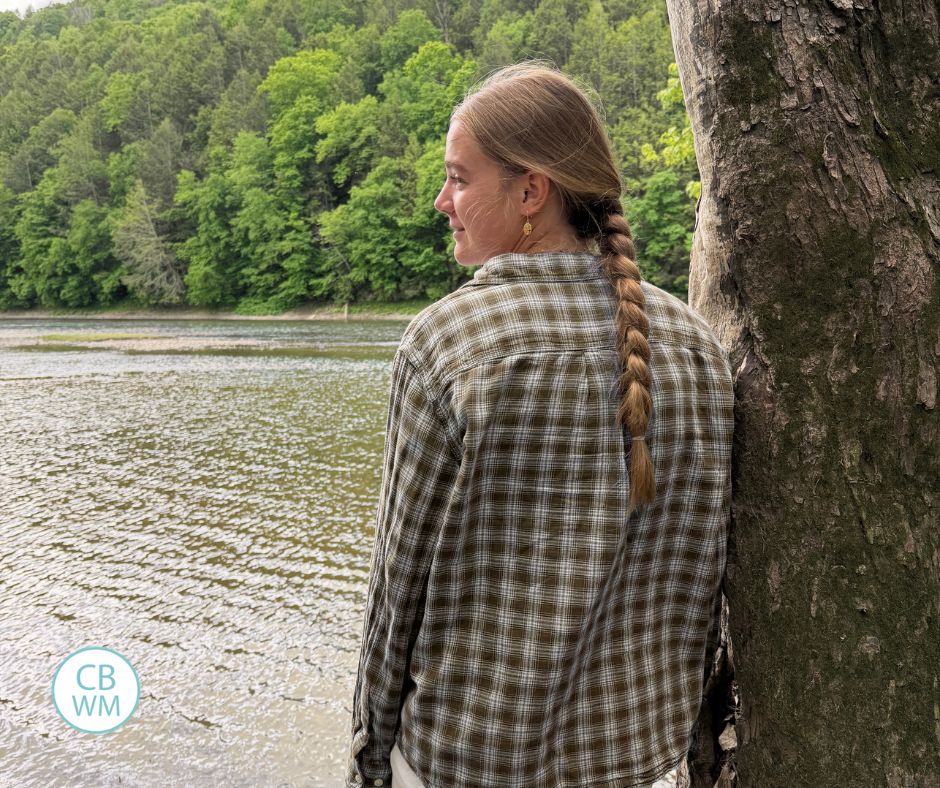 McKenna leaning on a tree