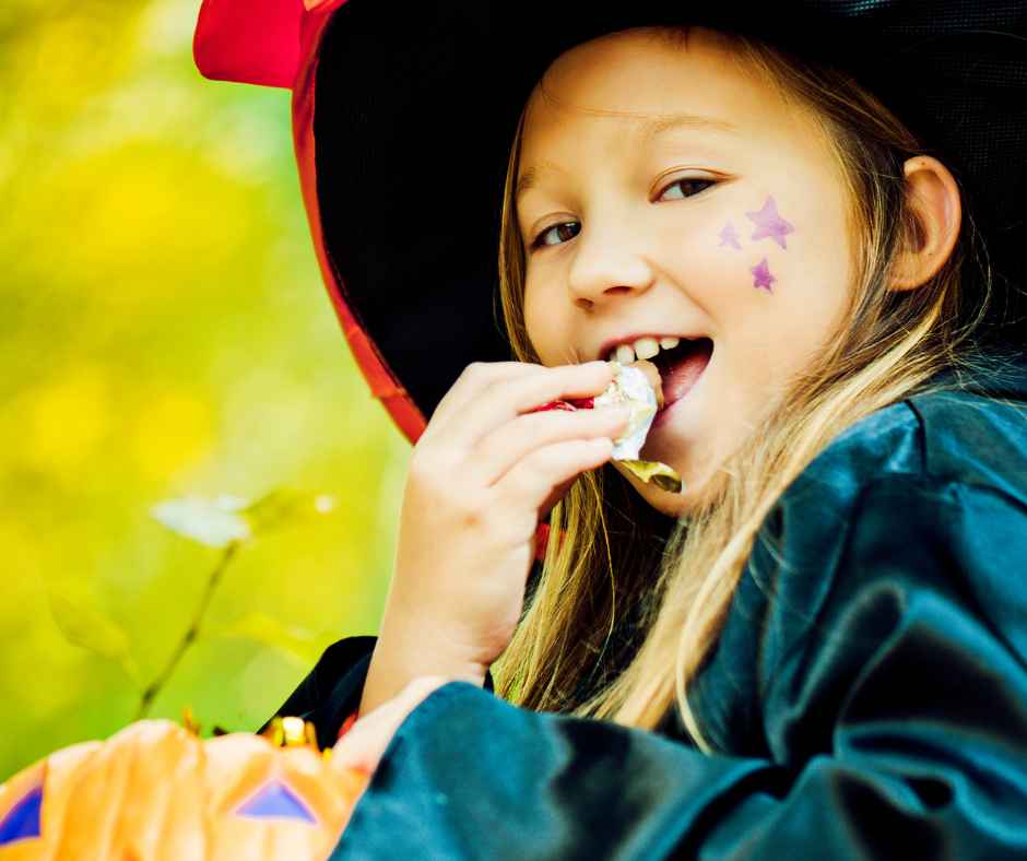Girl eating Halloween candy