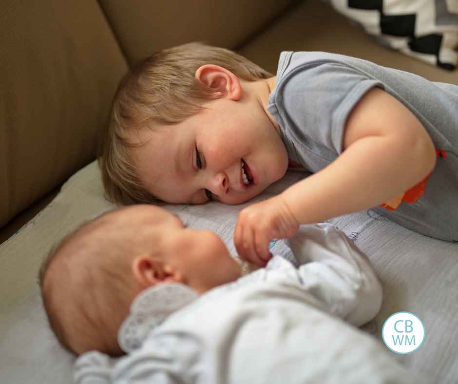 Toddler with his baby sibling