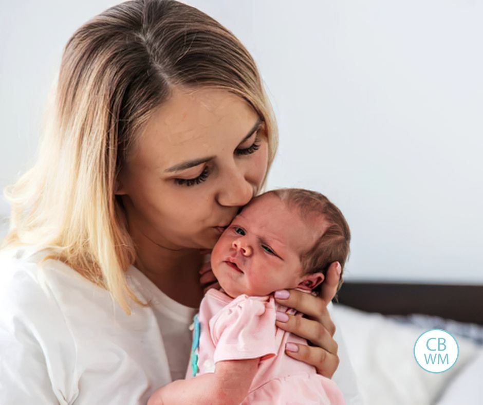 mom kissing her newborn baby on the head